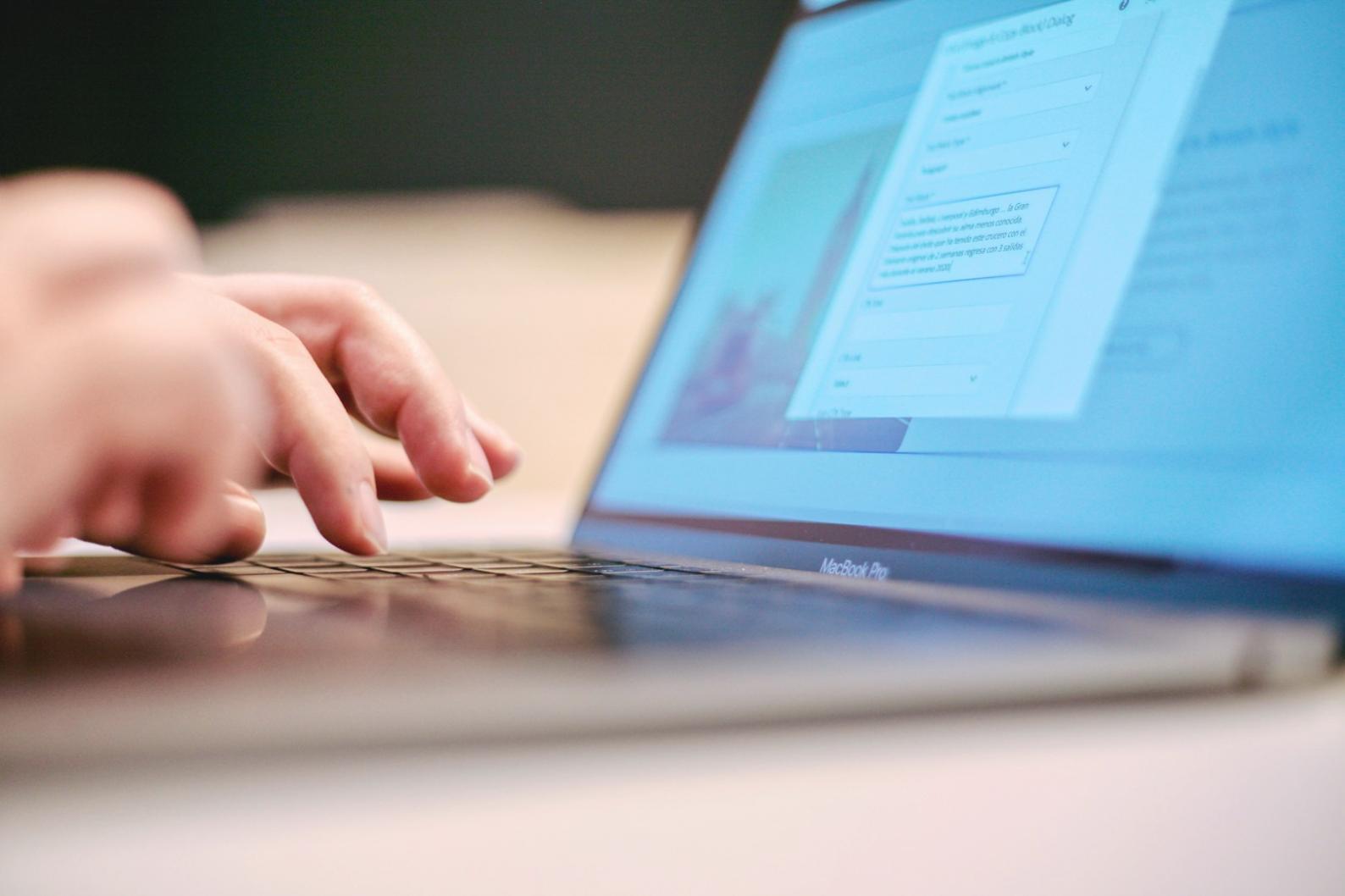 Student reviewing personal budget materials and taking notes during individual study session